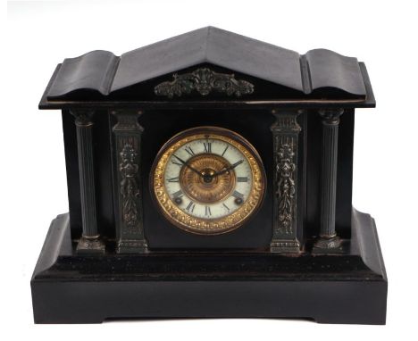 A Victorian ebonised steel mantle clock of architectural design, the white enamel dial with Roman numerals, 41cms wide.