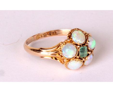 A 15ct gold opal and emerald flowerhead ring, approx UK size 'M', 2g.Condition ReportAll the stones sit firm in the setting, 