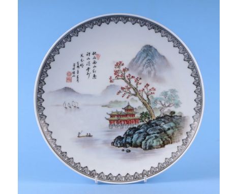 A Chinese Republic style shallow dish decorated with a river landscape and calligraphy, red seal mark to the underside, 27cms