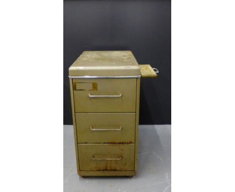 A vintage three drawer metal filing cabinet with stainless steel handles and a pull out slide to the side, 80 x 40cm 