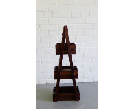 A teak three-tier caddy of pyramid form, 81cm 
