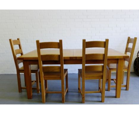 A solid oak contemporary dining table and chairs comprising the table with rectangular top on block supports together with a 