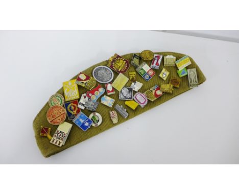 A Russian cap with a collection of vintage enamel cap badges (a lot)