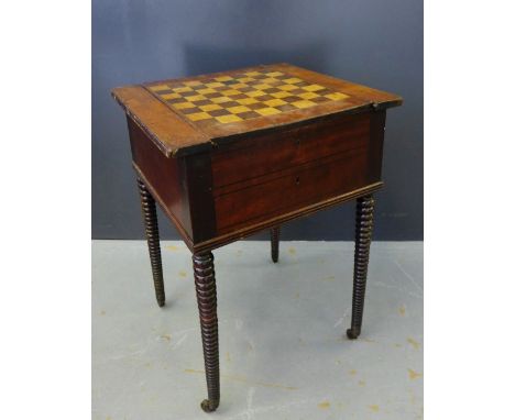 A mahogany games table with an inlaid checkered slide off top over four drawers on bobbin turned supports terminating in bras