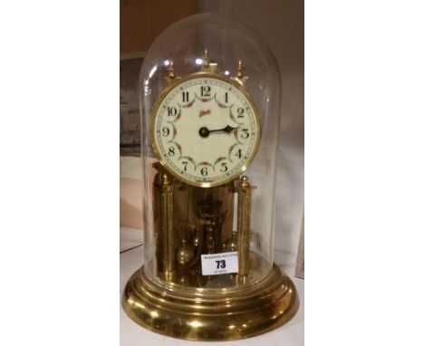 A Brass Anniversary Clock by Schaltz; with foliate design and Arabic numerals to dial.