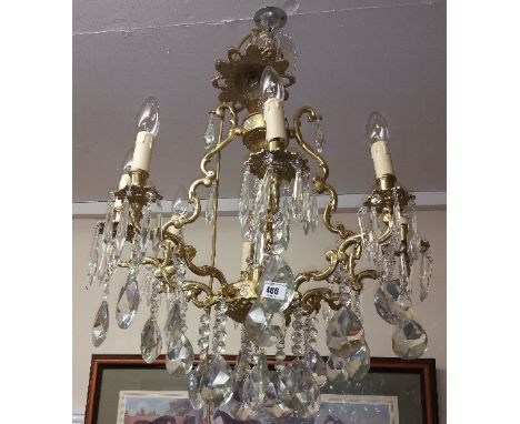 A Wonderful Crystal and Brass Eight Branch Chandelier; with rose.