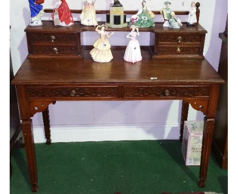 A Wonderful Late 19th Century Walnut Writing Desk; with highly carved front, gallery back with twin drawers under shelf, on s