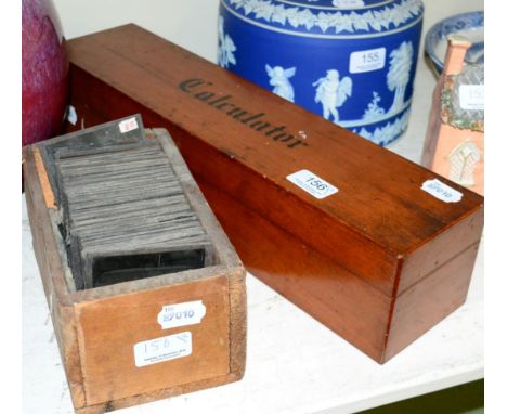 A wooden cased calculating slide rule, and magic lantern glass slides