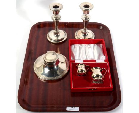 A pair of silver candlesticks, Birmingham 1907, with reeded borders; a silver capstan inkwell Elkington &amp; OC, Birmingham 