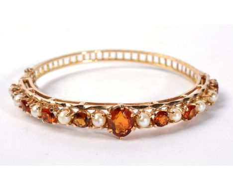 A 9 carat gold citrine and seed pearl bangle, 16.1g