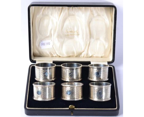 A matched set of six silver napkin rings, Birmingham 1914/18, with engine turned decoration, in a fitted case (no initials), 