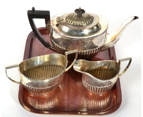A Canadian metalware three piece tea service, stamped Birks Sterling, part fluted oval form, the teapot 27.5cm long, 22.7ozt 