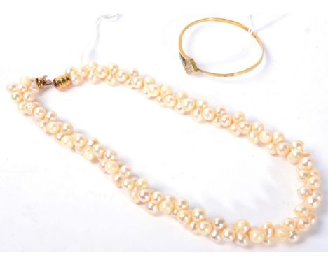 A cultured pearl torsade necklace, with a barrel clasp and a diamond bangle, an arrow-motif front pavé set with round brillia
