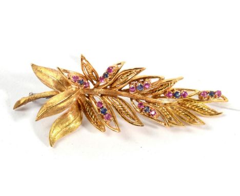 A ruby and sapphire set spray brooch, measures 6.5cm long, stamped '18K', 16.3g 