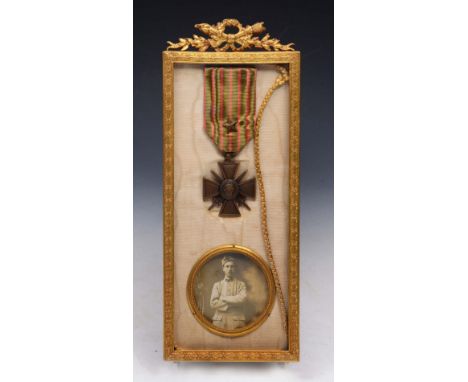 A FRENCH WWI MILITARY MEDAL WAR CROSS, Croix de de Guerre 1914, 1916, One Star; together with a circular portrait photograph 