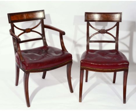 A SET OF SEVEN GEORGE IV MAHOGANY AND BRASS INLAID DINING CHAIRS consisting of a carver and six standards with sabre forelegs