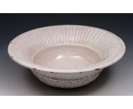 AN ITALIAN WHITE GLAZED FAIENCE BASIN with fluted rim, 36cm diameter