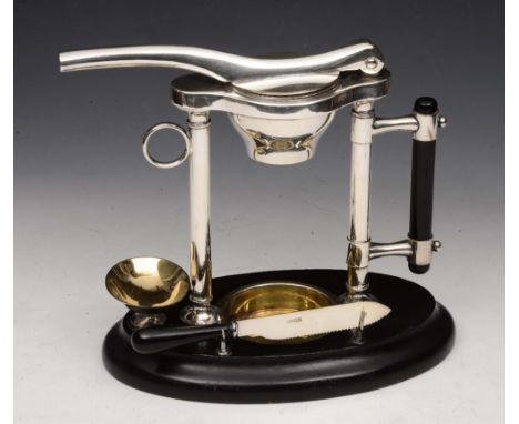 A MAPLES & CO CITRUS FRUIT SQUEEZER with silver plated mounts and on ebonised stand, Registered No. 87257, 22cm high