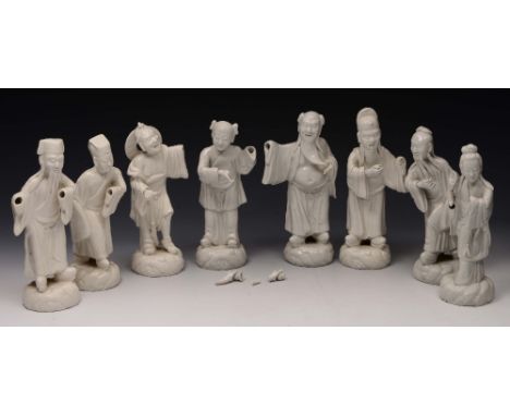 A COLLECTION OF EIGHT CHINESE WHITE GLAZED FIGURES, on scroll incised bases, approximately 23.5cm high (AF) (8)