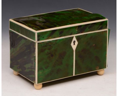 AN ANTIQUE GREEN STAINED TORTOISESHELL AND IVORY TEA CADDY, the interior fitted twin compartments enclosed by hinged rising l