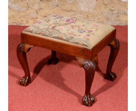 AN 18TH CENTURY STYLE WALNUT RECTANGULAR DRESSING STOOL with needlework seat and on four cabriole legs with carved claw and b