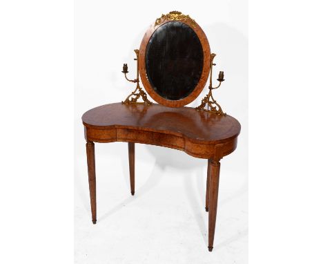 A FRENCH BURR WALNUT KIDNEY SHAPED DRESSING TABLE with swing mirror and gilt metal lamp holders, fitted one drawer on fluted 