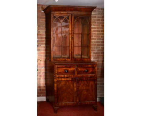 AN EARLY 19TH CENTURY MAHOGANY SECRETAIRE CABINET with glazed top and astragal doors, the fitted interior with fall front and