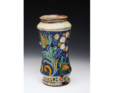 AN 18TH CENTURY ITALIAN MAIOLICA POTTERY ALBARELLO of waisted form decorated with blue, green and sienna glazed fruit and flo