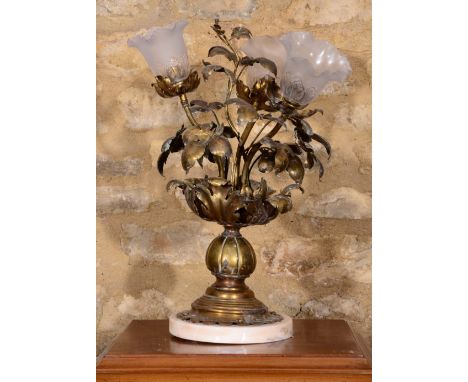 A PRESSED BRASS THREE LIGHT TABLE LAMP of foliate form on a marble plinth, 58cm high overall