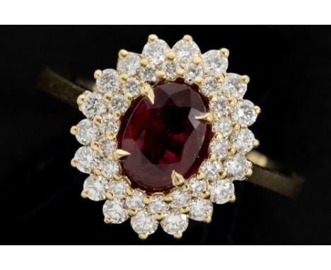 ring in yellow gold (18 carat) with an at least 1 carat ruby with an intense red pigeon blood colour surrounded by at least 0