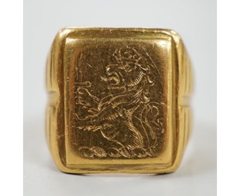 An antique yellow metal signet ring, engraved with crowned rampant lion (tired), size K/L, 14.1 grams.