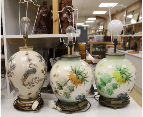 A pair of floral reverse decorated glass decorative table lamps and a similar crackle ware table lamp, 40cm not including lig