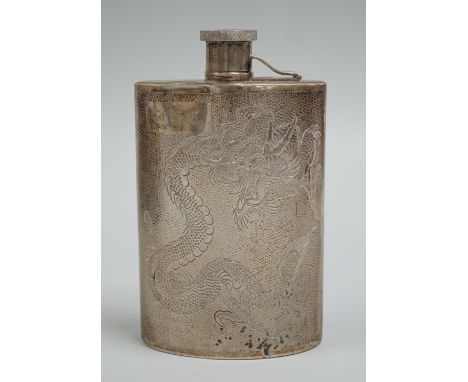 An early 20th century Chinese white metal hip flask, engraved with dragon, inscription and initials, 14.5oz, 6.7oz.