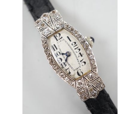 A lady's platine and diamond cluster set manual wind cocktail watch, on a leather strap.