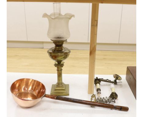 A brass Corinthian column oil lamp, two brass wall sconces and an 1823 copper saucepan