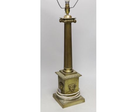 A large brass desk lamp in the form of a tapering column, on plinth base, 56cm to top of column