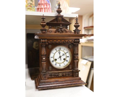 A late 19th century German carved and turned mahogany mantel clock, 56cm high