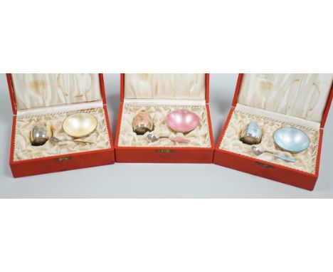 Three cased Danish sterling and enamel three piece condiments sets, by Volmer Bahner &amp; Co,  each with different coloured 
