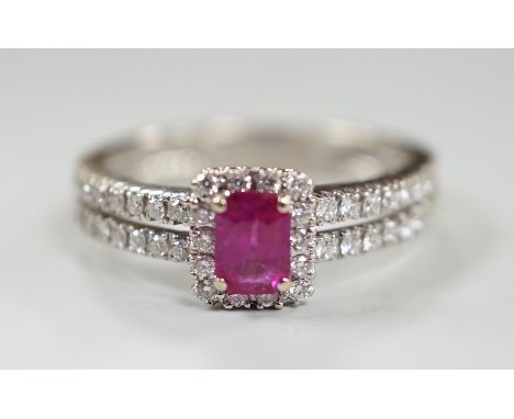 A modern 18ct white gold, single stone emerald cut ruby and diamond chip set cluster ring, with two row diamond chip set shou