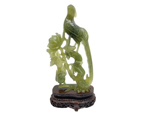 Carved jade figure of a phoenix perched on a flowering branch, upon a wooden stand, with original box, H27cm