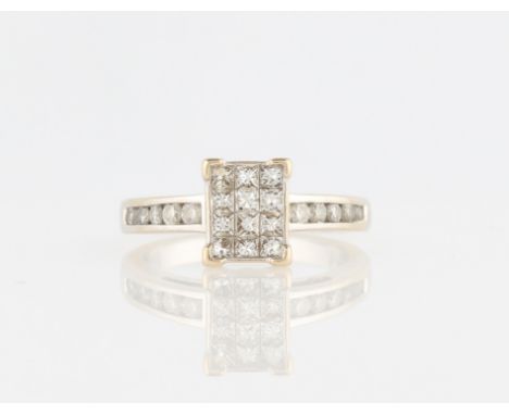 An 18ct white gold diamond cluster ring, the square head set with twelve princess cut diamonds, the shoulders each channel se