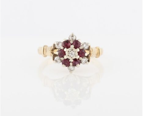 A hallmarked 9ct yellow gold ruby and diamond tiered cluster ring, claw set with a central round brilliant cut diamond, surro