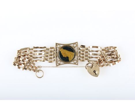 A hallmarked 9ct yellow gold gate bracelet, set with an enamelled Victorian, sixpence coin, with heart padlock clasp.