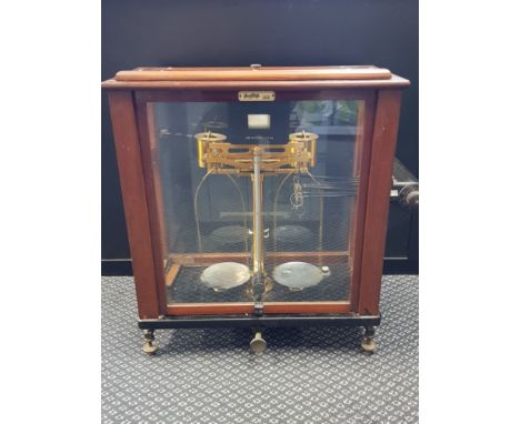 Set of brass precision scales in mahogany glazed case.