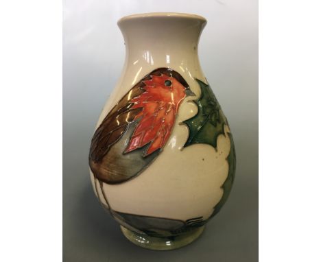 A Moorcroft bird with holly on white background vase, height 13.5cm.