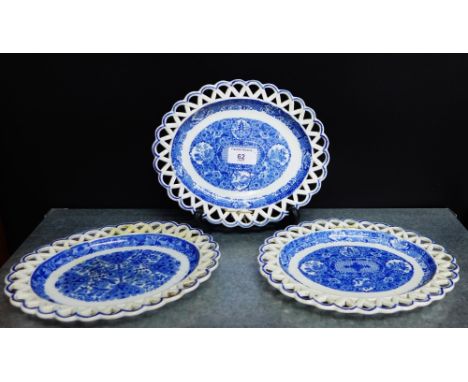 A pair of pearl ware blue and white 'Pagoda' patterned oval stands with reticulated rims, together with another (one restored