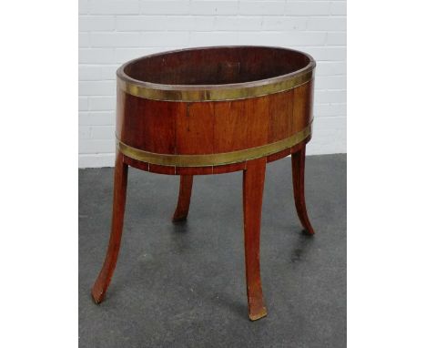 An oak and brass bound oval planter, 76 x 66cm
