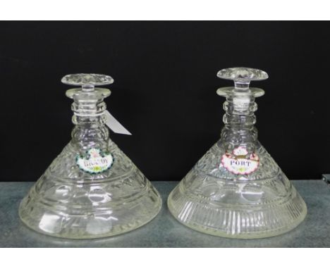 Two triple ring necked flat bottomed ships decanters with mushroom stoppers, together with enameled brandy and port decanter 