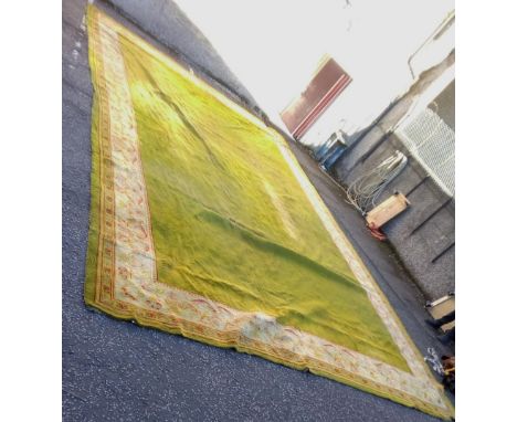 A large carpet with green field and floral border, (a/f) 790 x 472cm