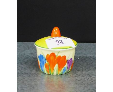 A Clarice Cliff Bizarre 'Crocus' patterned small pot and cover, 7cm high 
